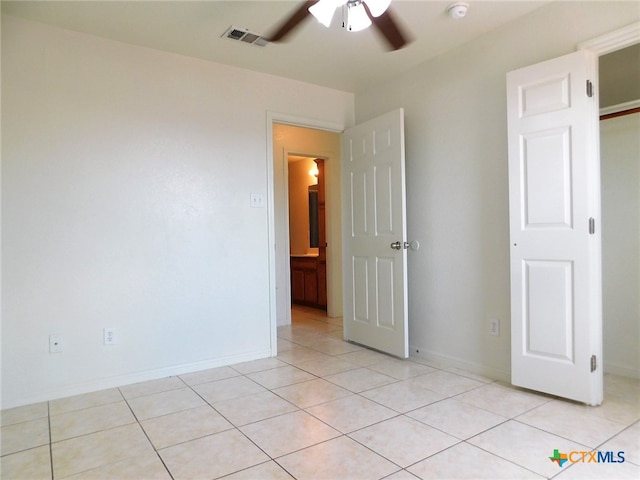 unfurnished bedroom with light tile patterned flooring and ceiling fan