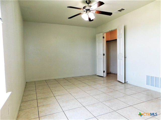 spare room with light tile patterned flooring and ceiling fan