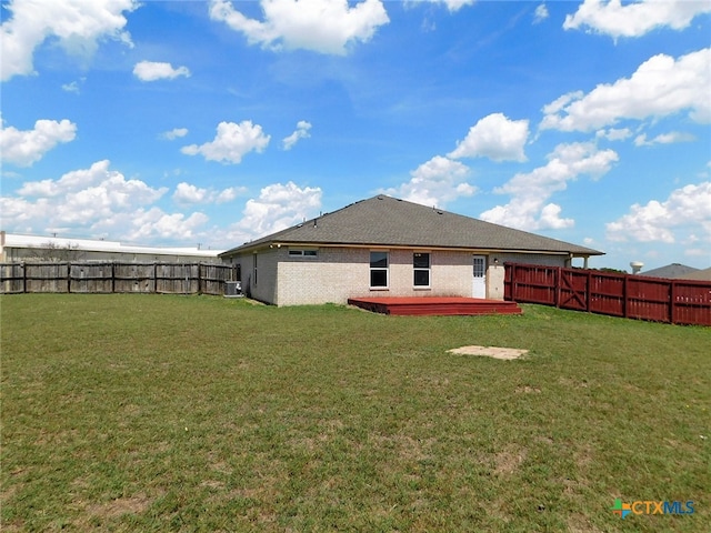 back of property with a patio, central AC unit, and a yard