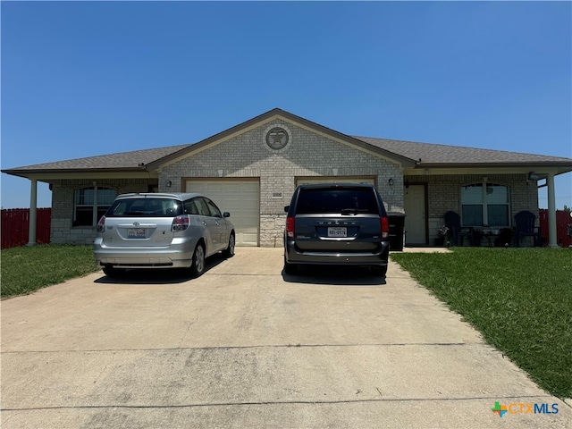 single story home featuring a garage and a front lawn