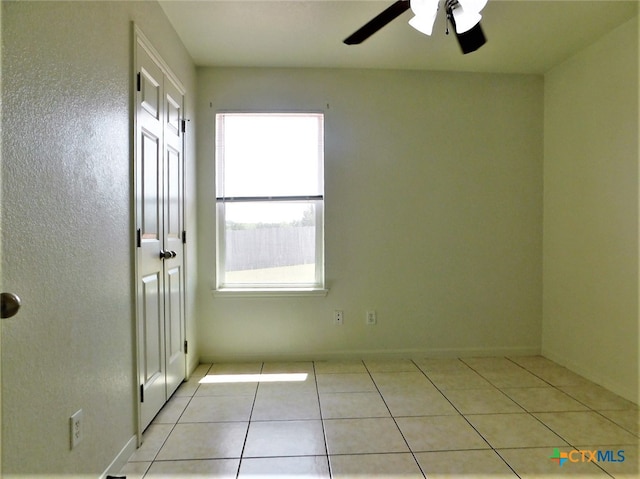 unfurnished room featuring ceiling fan and light tile patterned flooring