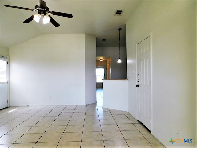 tiled spare room with a wealth of natural light, vaulted ceiling, and ceiling fan