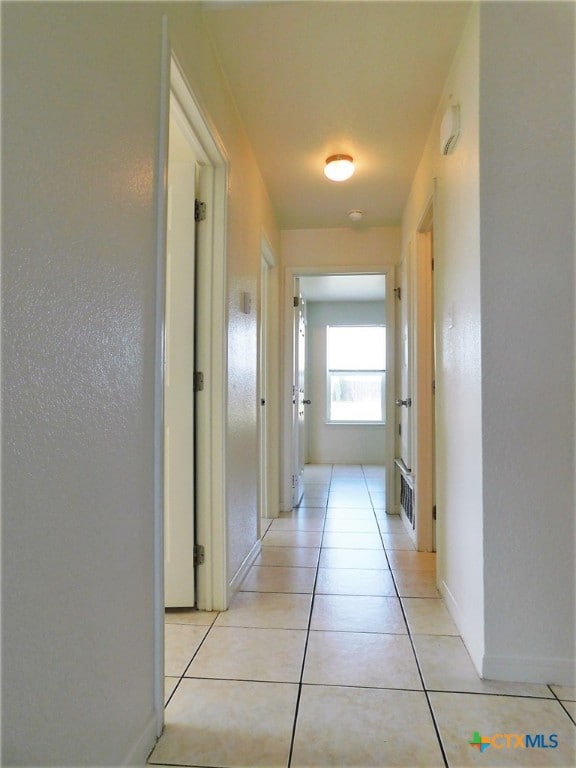 hall featuring light tile patterned flooring