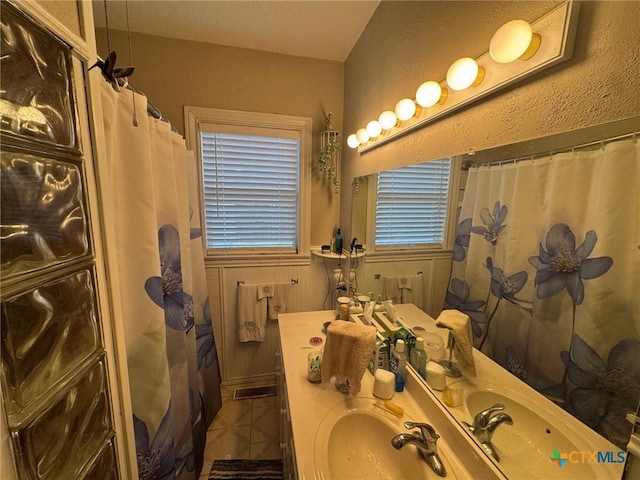 bathroom featuring vanity, tile patterned floors, and curtained shower