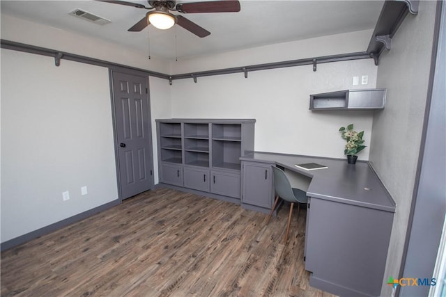 home office with ceiling fan and dark hardwood / wood-style flooring