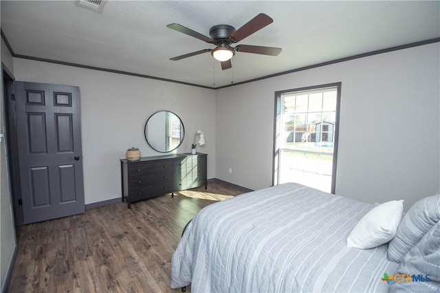 bedroom featuring ceiling fan, dark hardwood / wood-style floors, and crown molding