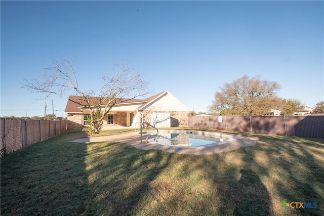 back of house with a yard and a patio