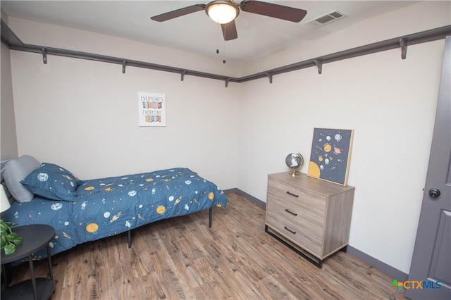 bedroom with ceiling fan and wood-type flooring