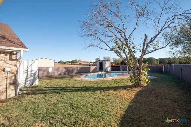 view of yard with a fenced in pool and a storage unit