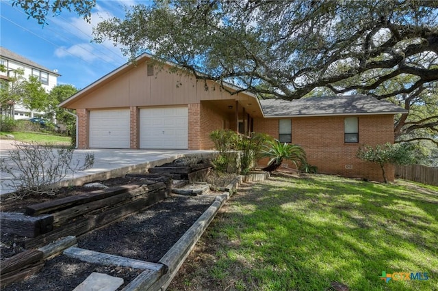 ranch-style home with an attached garage, a front yard, and brick siding