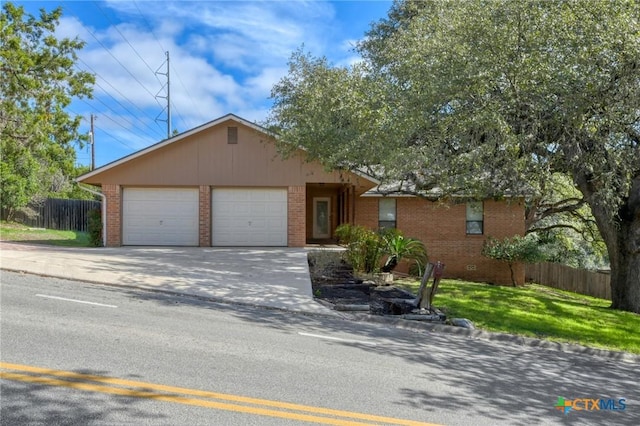 ranch-style house with a front lawn, brick siding, fence, and an attached garage