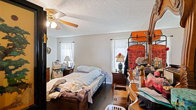 bedroom featuring wood finished floors, a textured ceiling, and ceiling fan