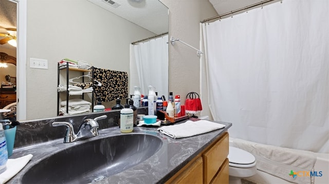 bathroom featuring visible vents, shower / bath combo, vanity, and toilet