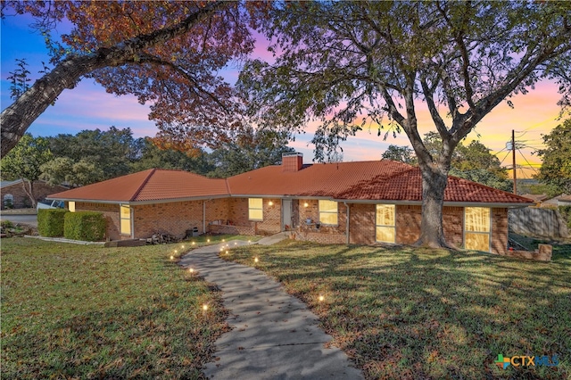 ranch-style home featuring a yard