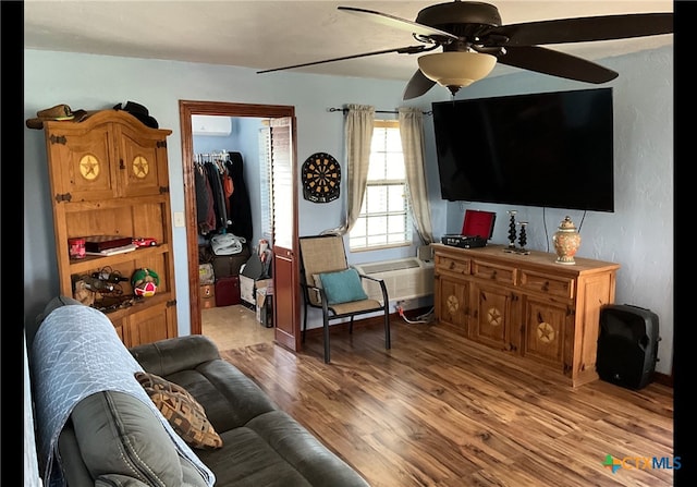 living room featuring ceiling fan and light hardwood / wood-style flooring