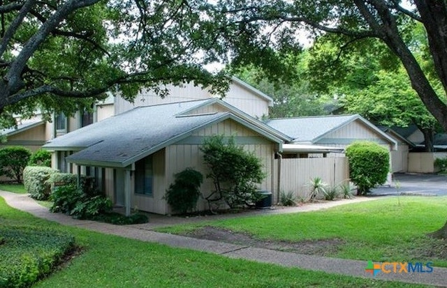 view of side of home featuring a lawn