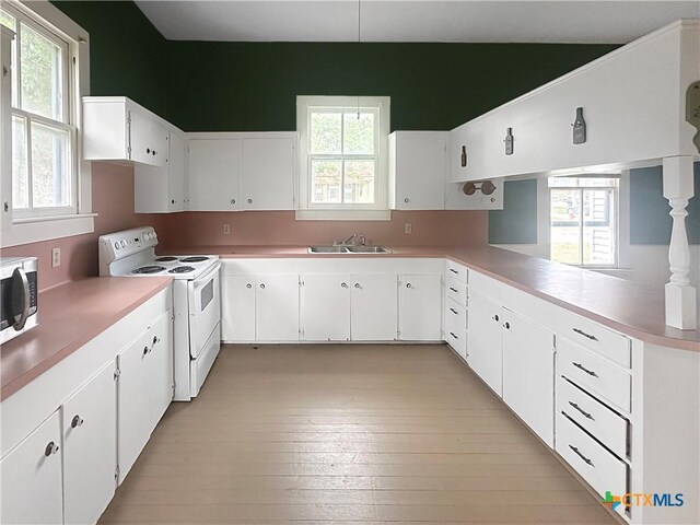 307 N Pecan St, Moulton, TX 77975 - kitchen with stainless steel microwave, plenty of natural light, a sink, and white electric range