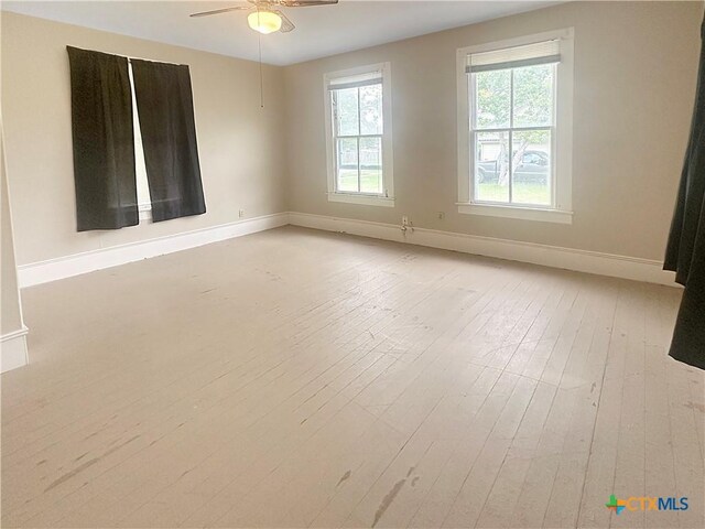 307 N Pecan St, Moulton, TX 77975 - spare room featuring baseboards, light wood finished floors, and ceiling fan