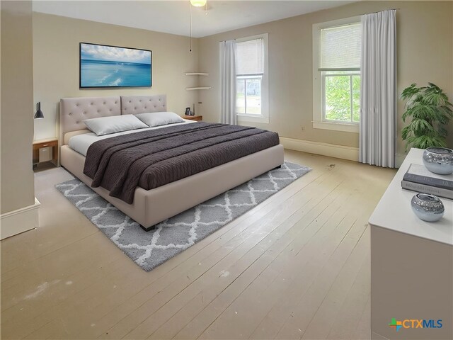 307 N Pecan St, Moulton, TX 77975 - bedroom with baseboards and wood finished floors
