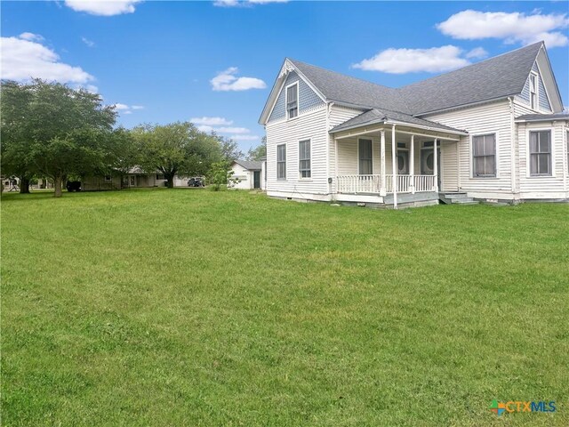 307 N Pecan St, Moulton, TX 77975 - exterior space with a porch, a yard, and a shingled roof