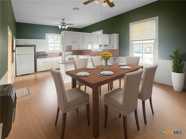 307 N Pecan St, Moulton, TX 77975 - dining area featuring visible vents, ceiling fan, and light wood-type flooring