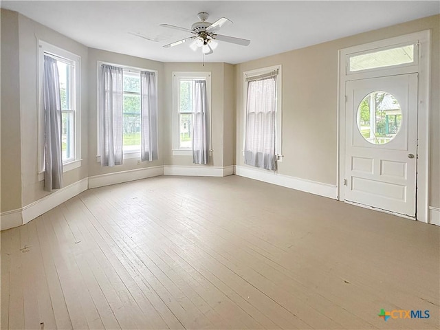 307 N Pecan St, Moulton, TX 77975 - foyer entrance with baseboards, ceiling fan, and hardwood / wood-style floors