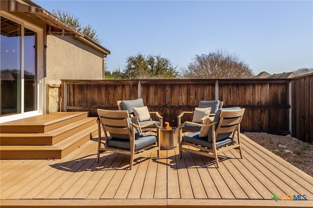 wooden deck with fence and an outdoor fire pit