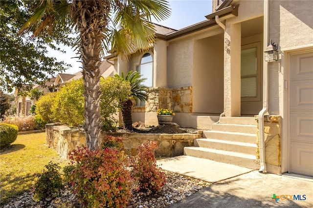 property entrance with stucco siding