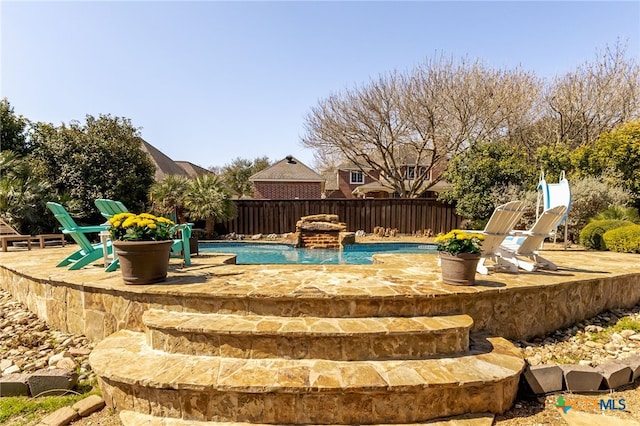 view of pool with a fenced in pool, a patio, and fence