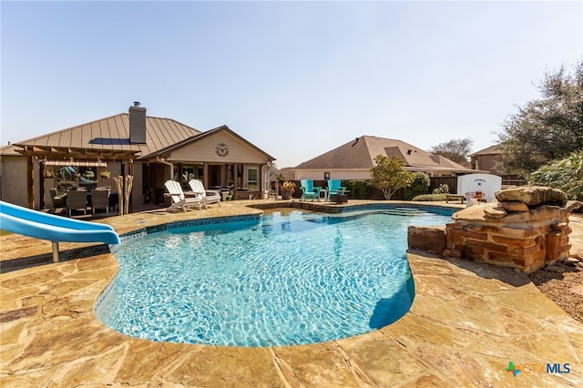 view of swimming pool with a fenced in pool, a patio, a water slide, and fence