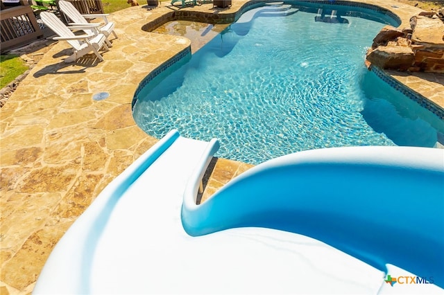 outdoor pool with a patio area