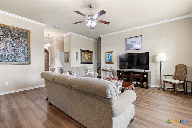 living room featuring ceiling fan, wood-type flooring, and ornamental molding