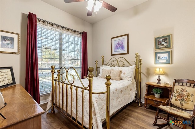 bedroom with ceiling fan and dark hardwood / wood-style flooring