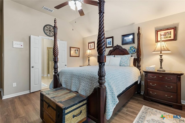 bedroom featuring ceiling fan, dark hardwood / wood-style flooring, and lofted ceiling