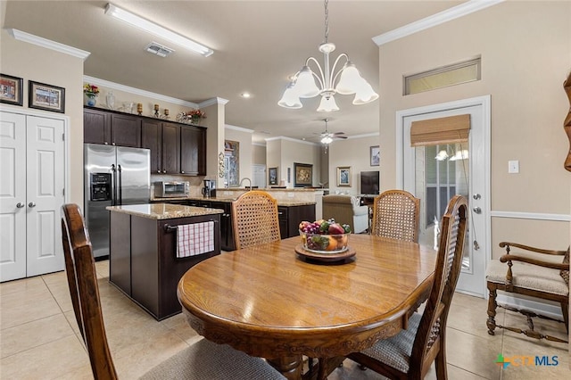 tiled dining space featuring ceiling fan with notable chandelier and ornamental molding