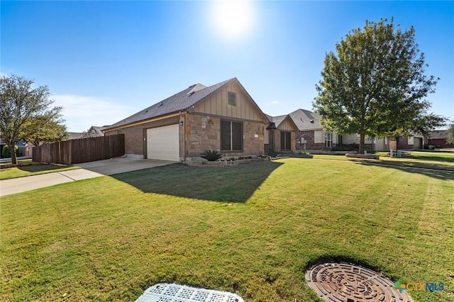 view of front of home with a front lawn and a garage