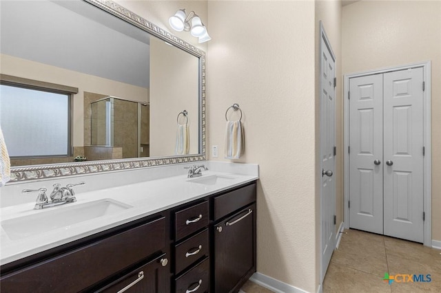 bathroom with vanity, tile patterned floors, and a shower with door