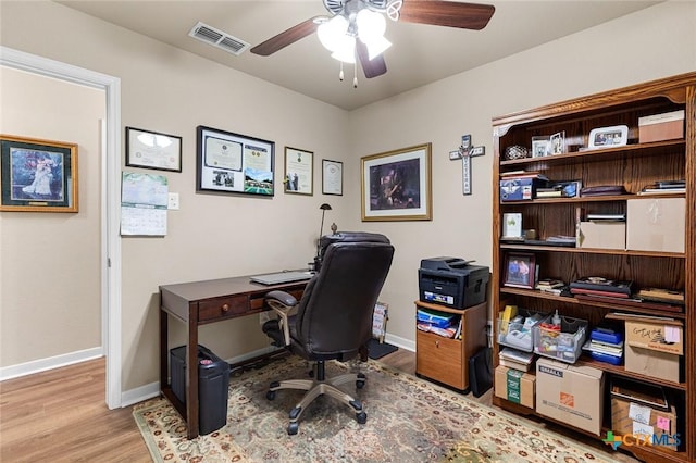 home office featuring light hardwood / wood-style flooring and ceiling fan