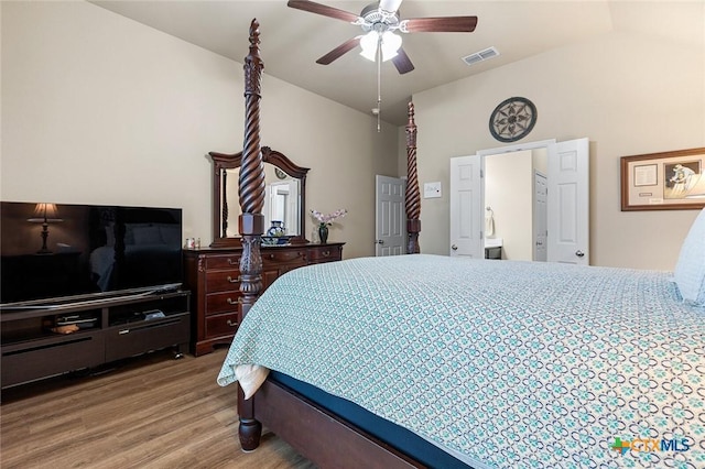 bedroom with ceiling fan, vaulted ceiling, and hardwood / wood-style flooring