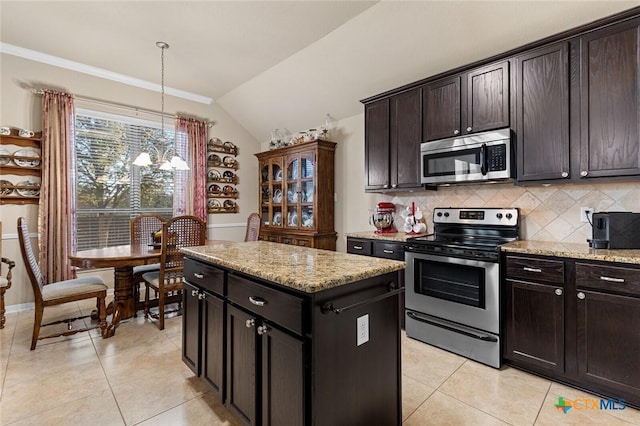 kitchen featuring a center island, stainless steel appliances, backsplash, pendant lighting, and vaulted ceiling