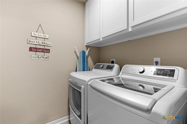 laundry area featuring cabinets and independent washer and dryer