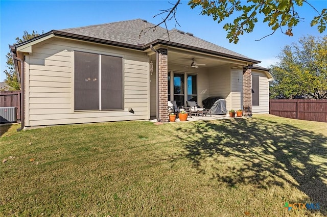 rear view of house with a lawn, ceiling fan, and a patio area