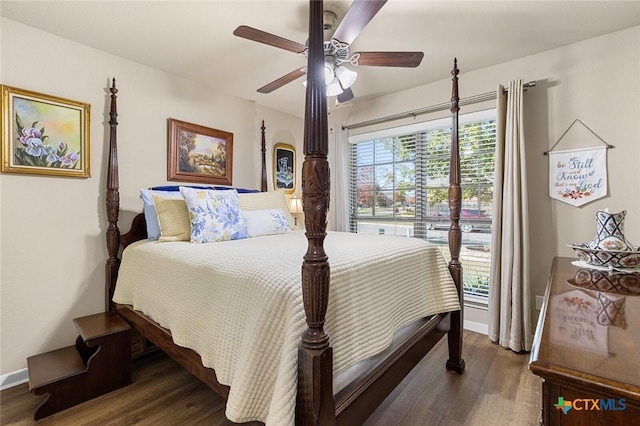 bedroom with ceiling fan and dark hardwood / wood-style flooring