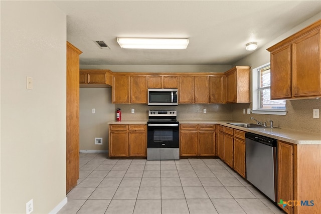 4612 Shawn Dr, Killeen, TX 76542 - kitchen with decorative backsplash, sink, light tile patterned floors, and stainless steel appliances