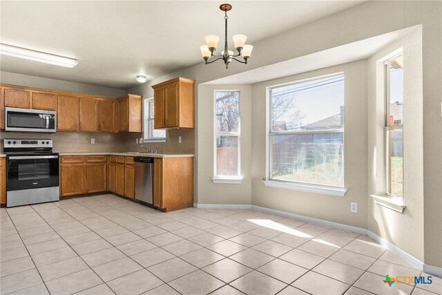 4612 Shawn Dr, Killeen, TX 76542 - kitchen featuring a chandelier, decorative light fixtures, decorative backsplash, light tile patterned floors, and appliances with stainless steel finishes