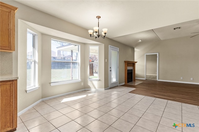 4612 Shawn Dr, Killeen, TX 76542 - interior space with ceiling fan with notable chandelier, light tile patterned flooring, and vaulted ceiling