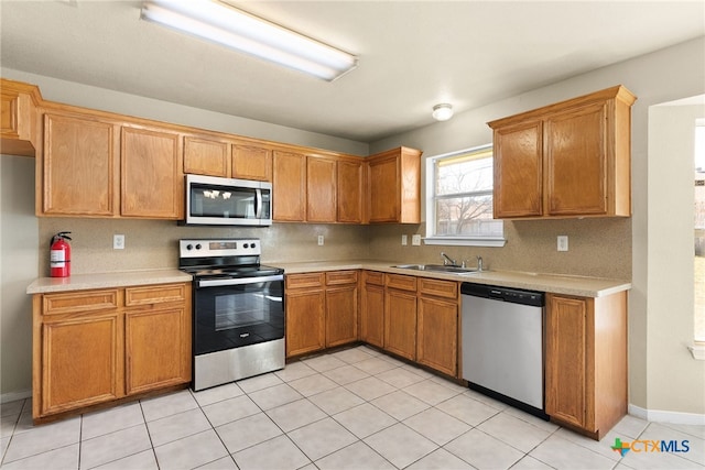 4612 Shawn Dr, Killeen, TX 76542 - kitchen with backsplash, sink, light tile patterned floors, and appliances with stainless steel finishes