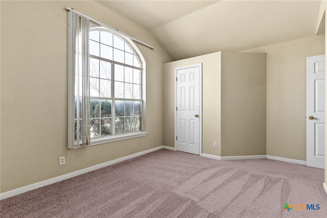 4612 Shawn Dr, Killeen, TX 76542 - unfurnished bedroom featuring multiple windows, light carpet, and vaulted ceiling