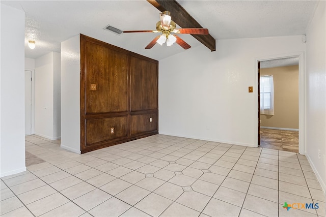 2013 Moonlight Dr, Killeen, TX 76543 - unfurnished room with lofted ceiling with beams, ceiling fan, and a textured ceiling