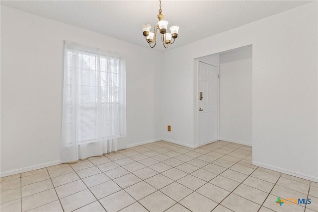 2013 Moonlight Dr, Killeen, TX 76543 - tiled spare room with a notable chandelier and a textured ceiling